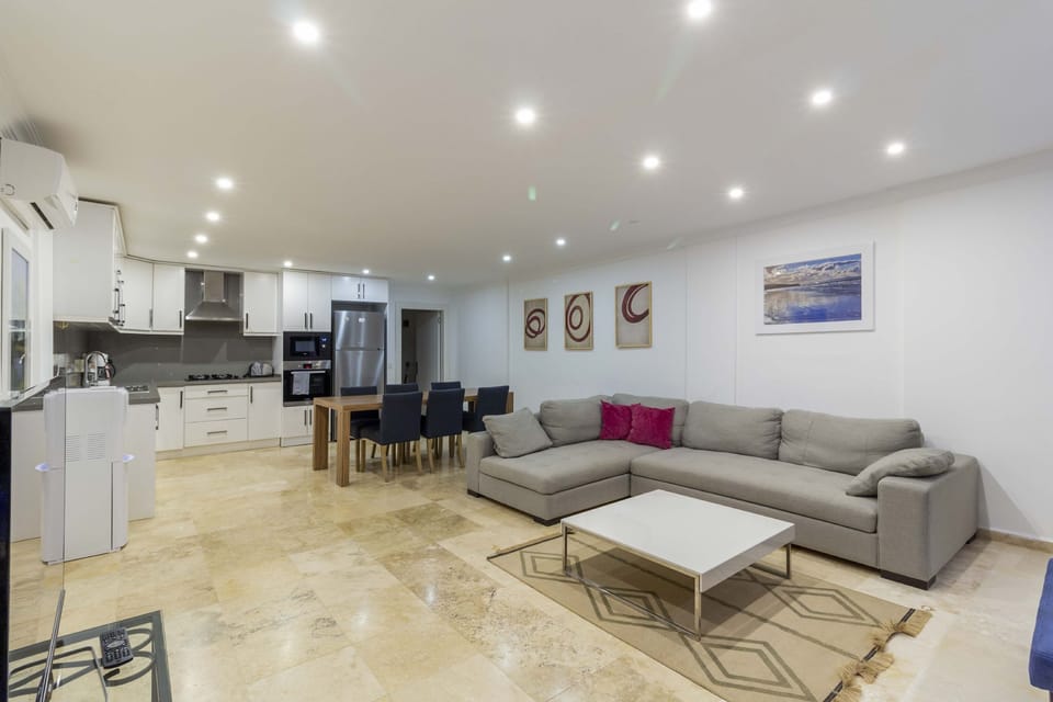Open plan living area with doors leading to terrace and pool