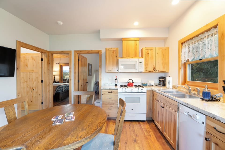 A fully stocked kitchen with dining seating for four. | Main Level