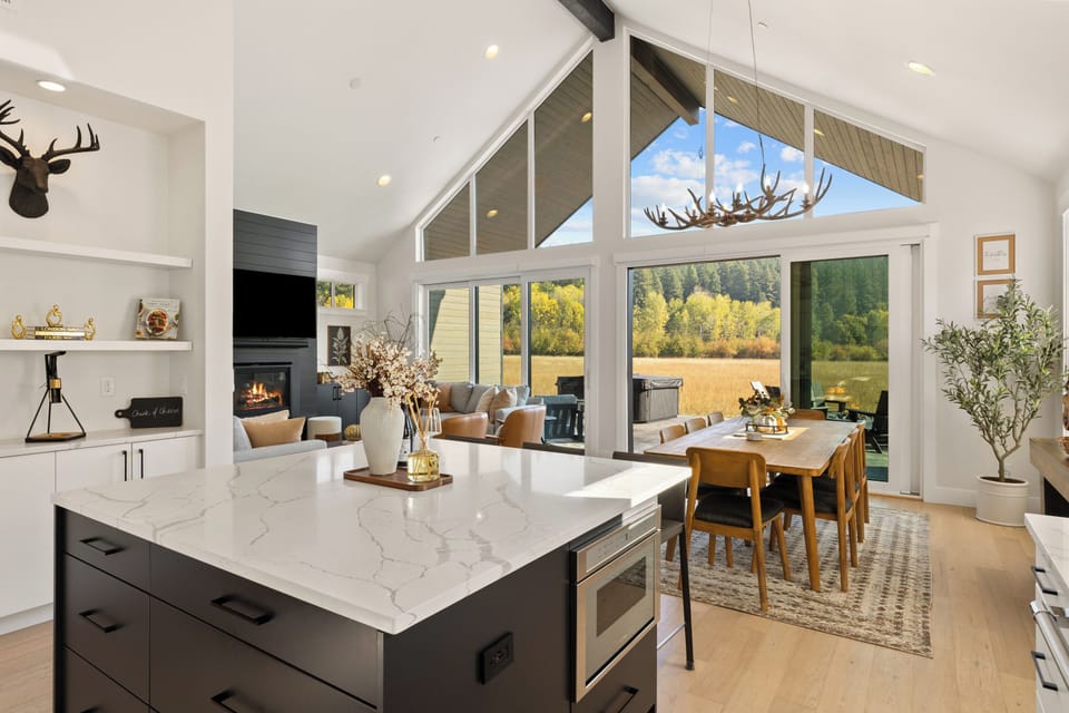Chef’s island brings everyone together, framed by calming meadow views.