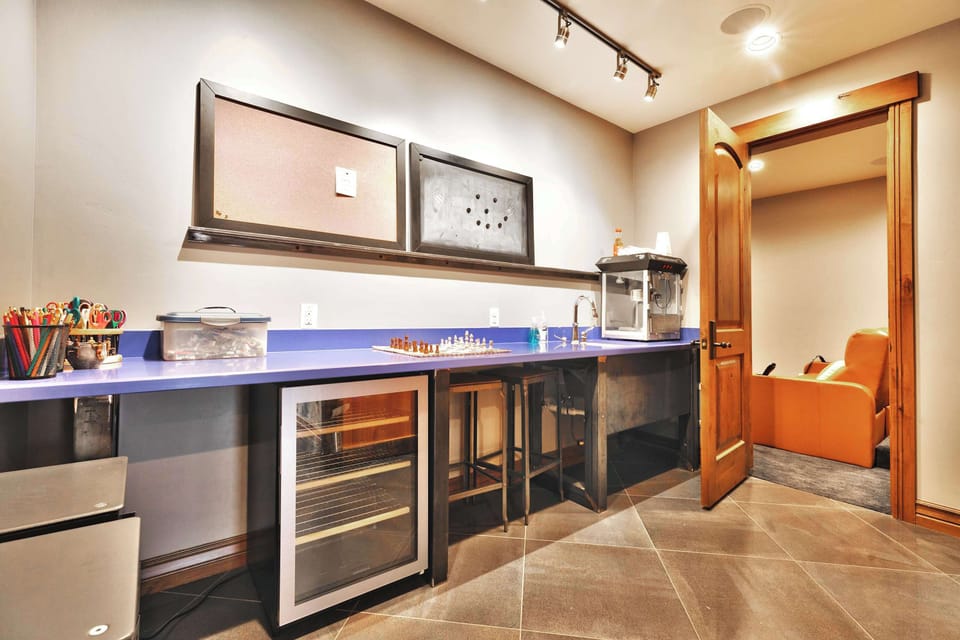 Theater room (bottom floor): Recliner seating, popcorn station, Smart TV, Sonos sound system