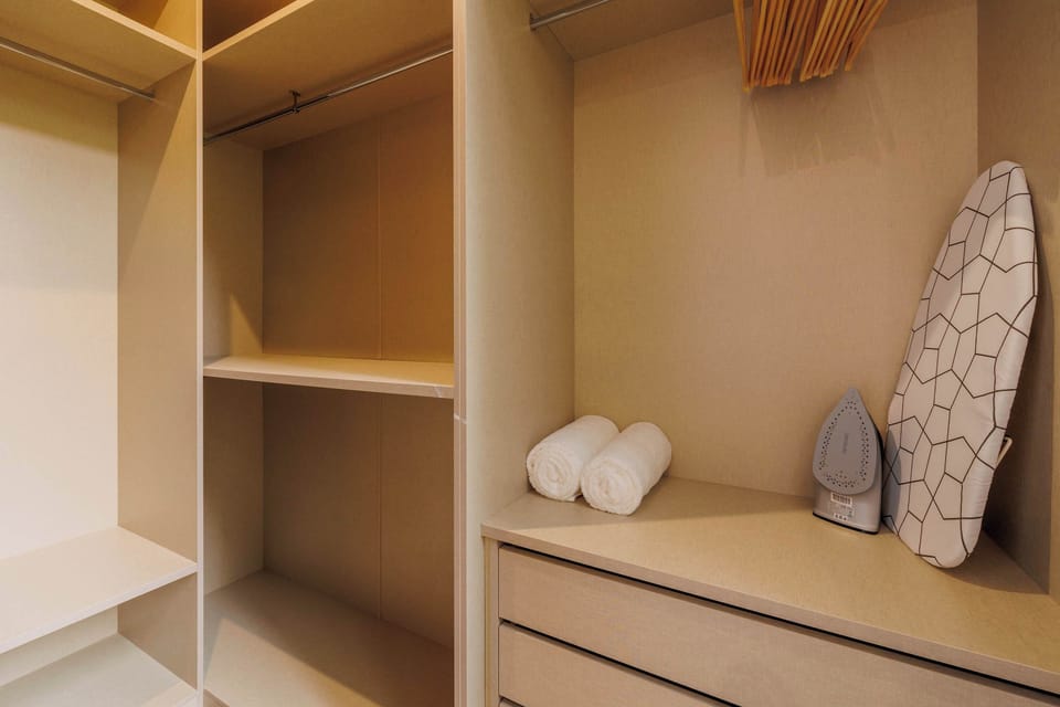 Open closet with shelves and drawer.