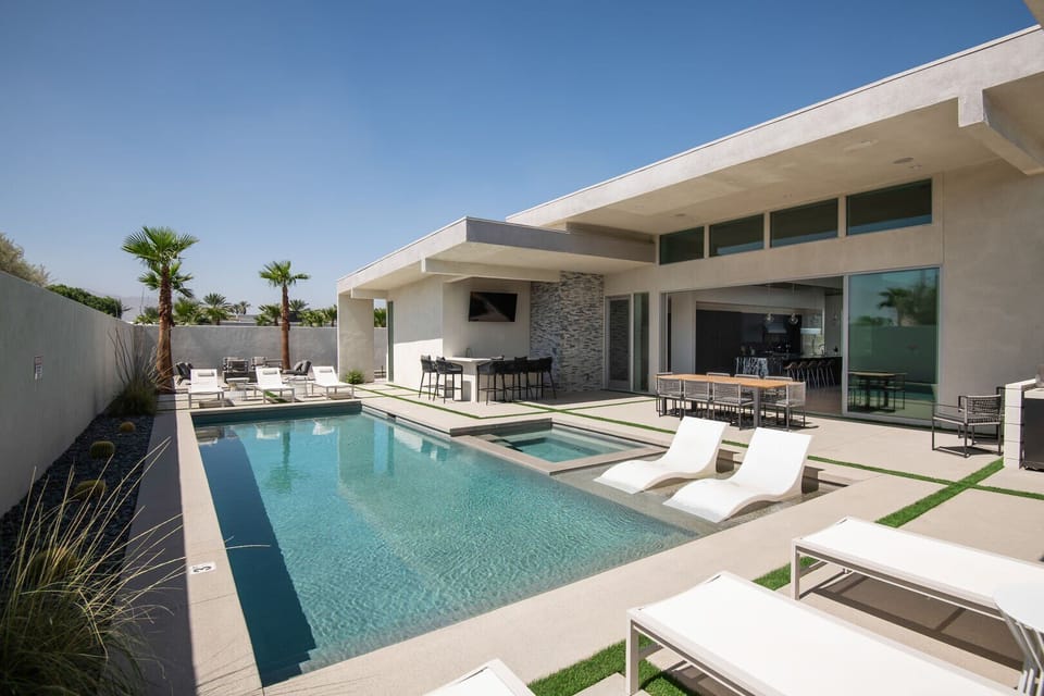 Sun-drenched luxury: The private pool, in-ground spa, swim-up loungers, and full outdoor bar create the ultimate desert pool day.