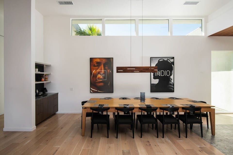 Enjoy large group dinners at the oversized dining table for 10+, complete with modern lighting and a dedicated wet bar area.