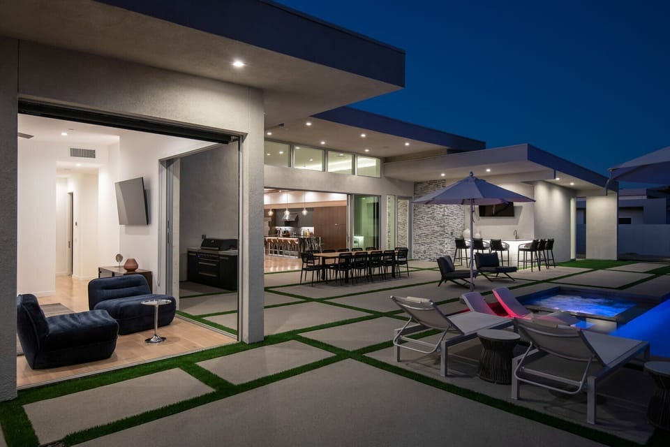 From the primary suite, look out over the private patio with direct access to the outdoor kitchen, dining, and pool area.