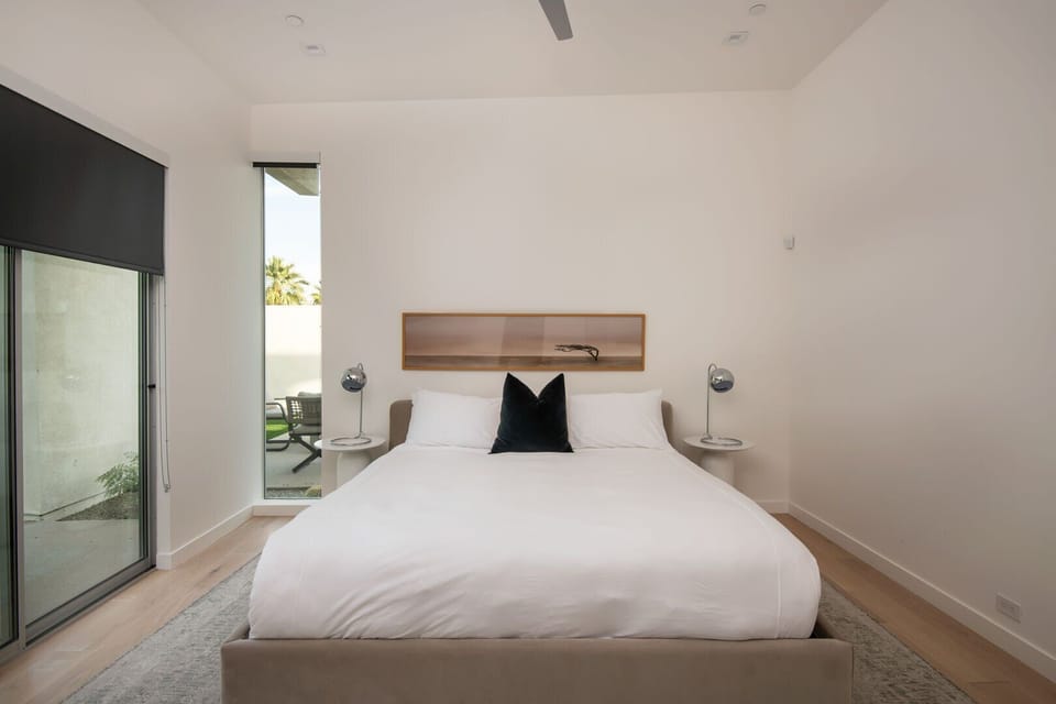 A light-filled queen suite with a comfy bed and a window wall that opens up to the private patio.