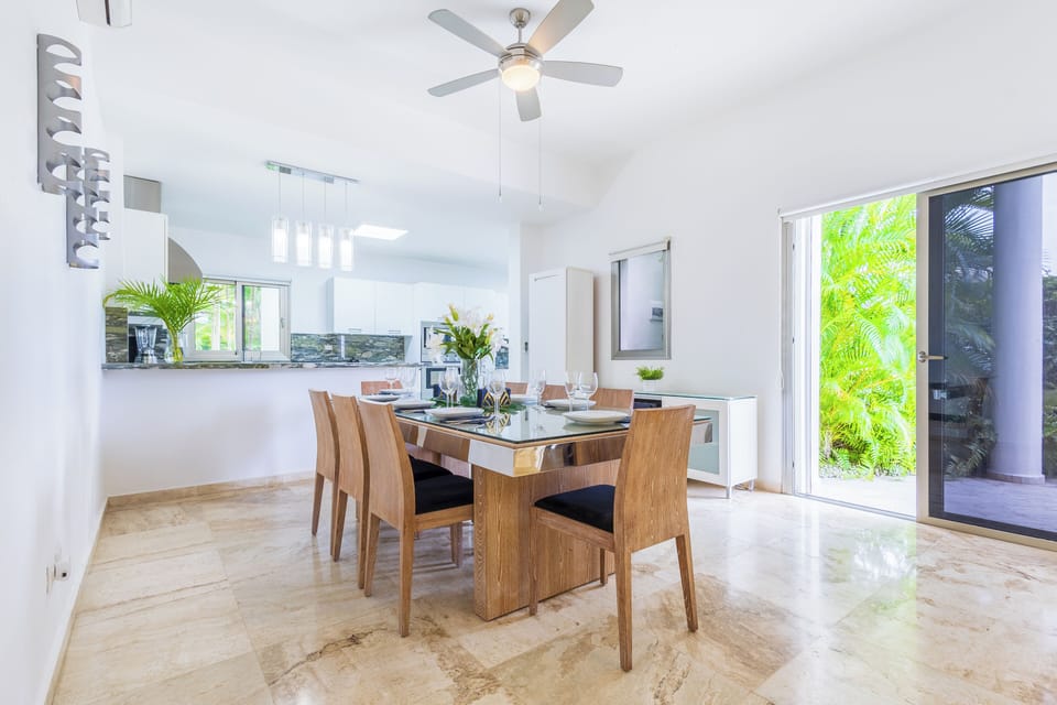 Spacious dining area with large wooden table and seating for eight.