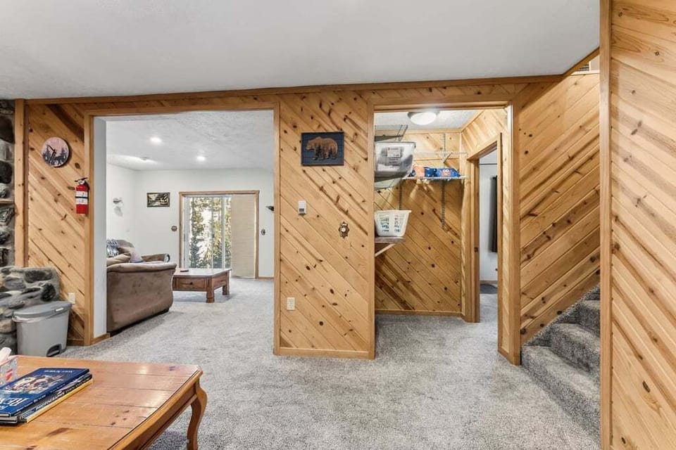 Warm knotty pine walls at 279 Shorewood Drive create a cozy mountain retreat atmosphere as you explore this inviting home's open layout and comfortable living spaces.