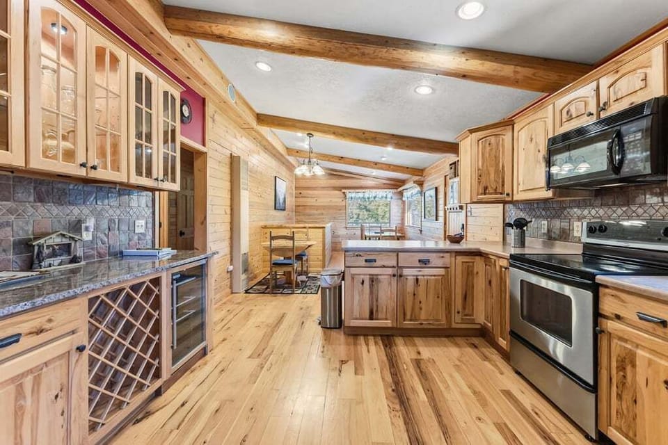 Your spacious kitchen at 279 Shorewood Drive  invites home-cooked memories with rustic wood cabinetry, granite counters, and modern appliances.