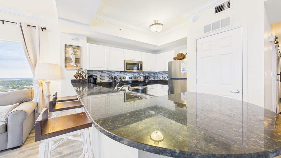 Kitchen equipped with breakfast bar