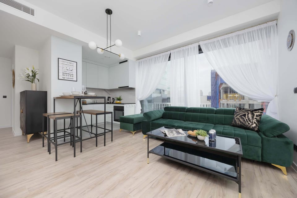 The harmonious combination of the living and dining areas provides an optimal opportunity to relax and unwind after a day spent exploring Warsaw.