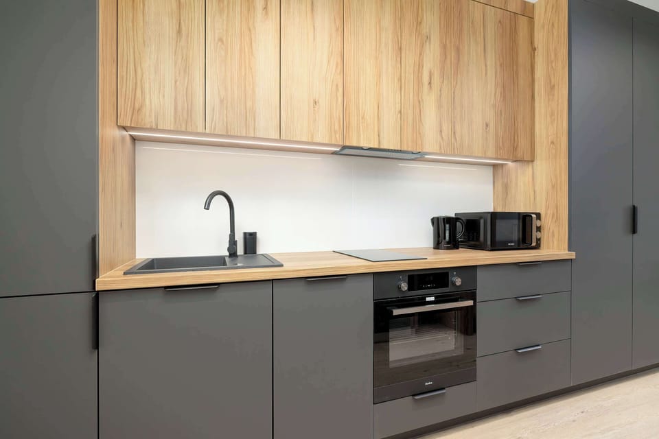 Kitchen workspace with wooden backsplash – Functional and elegant space perfect for preparing meals.