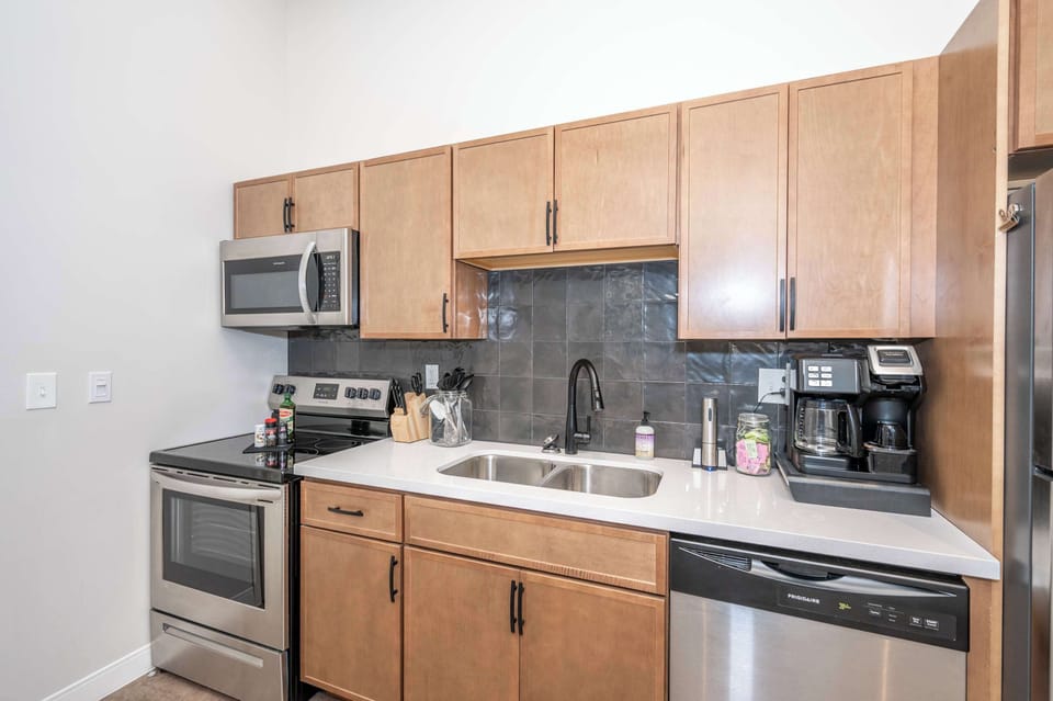 The sleek kitchen offers ample space & all the comforts of home​