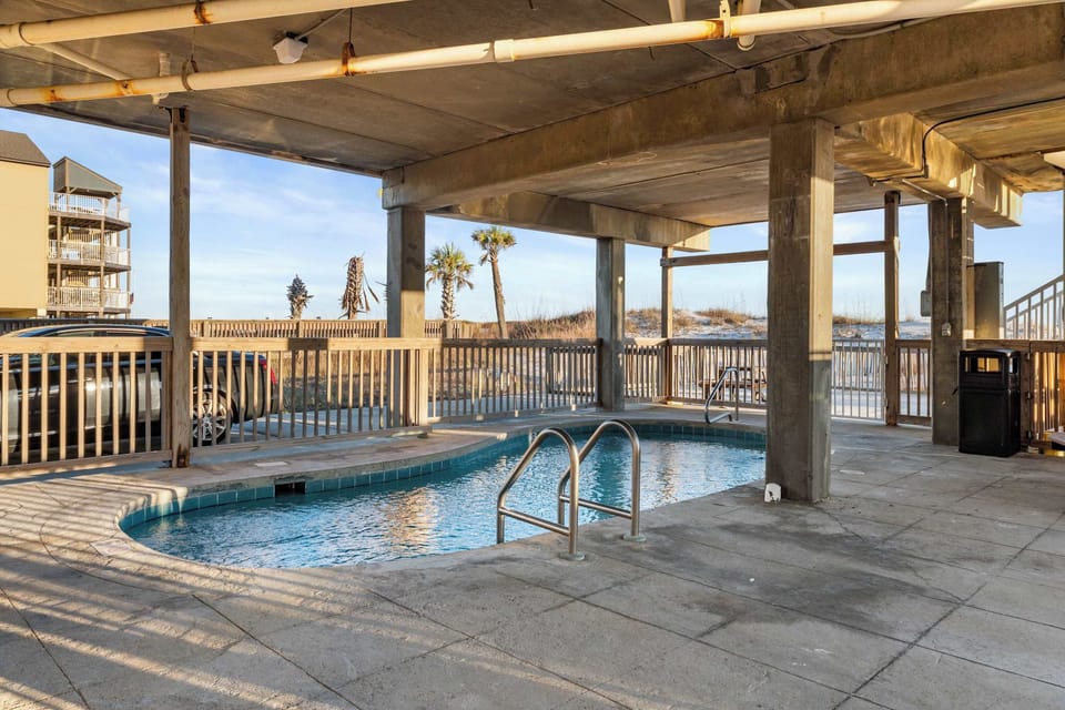 Covered Pool under the complex.  Perfect for getting out of the sun after a day at the beach.
