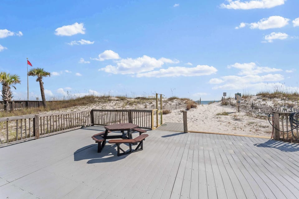 The direct beach access leads back to the front sun deck with an outdoor shower to rinse all the sand off!
