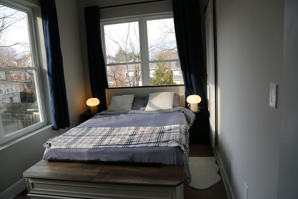 Relax in a bright bedroom with blackout curtains for sleeping late. 