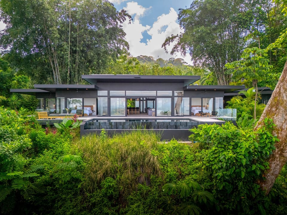 View of back of the Home and infinity edge pool