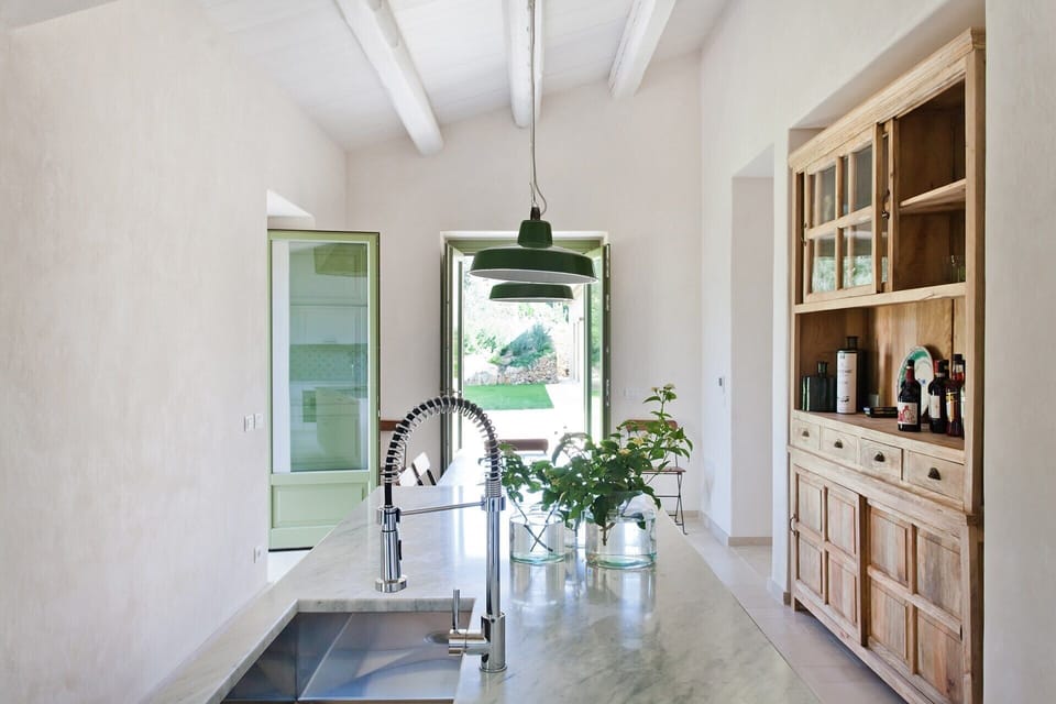 The main house kitchen opens out to the al fresco dining area.