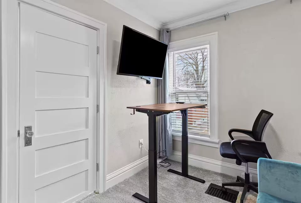 Bedroom 3 desk converts sit/stand; TV as 2nd monitor; outlets provided.