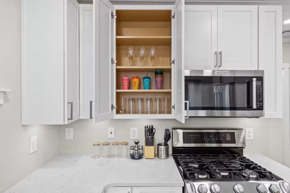Fully stocked kitchen with appliances, cookware, coffee makers & baking items