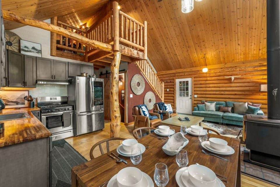 Spacious living room and open concept kitchem with vaulted ceilings and stunning views