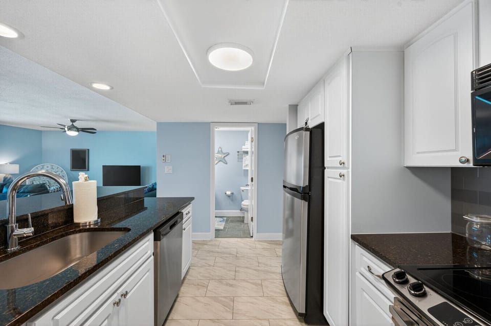 Clean, open kitchen view w/ modern appliances & easy access to the living area.