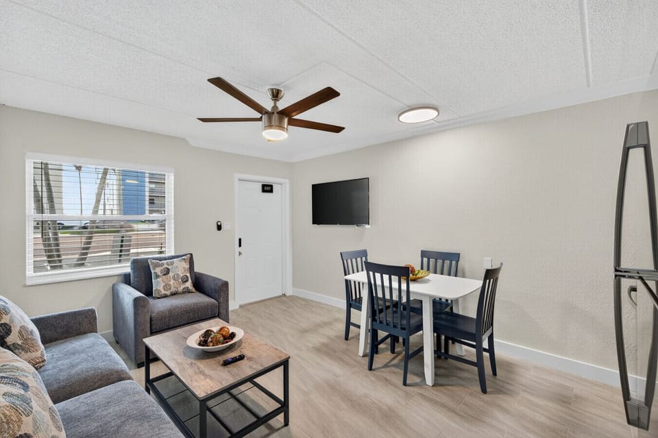 Wide view of the living & dining space w/ ceiling fan and room to unwind together.