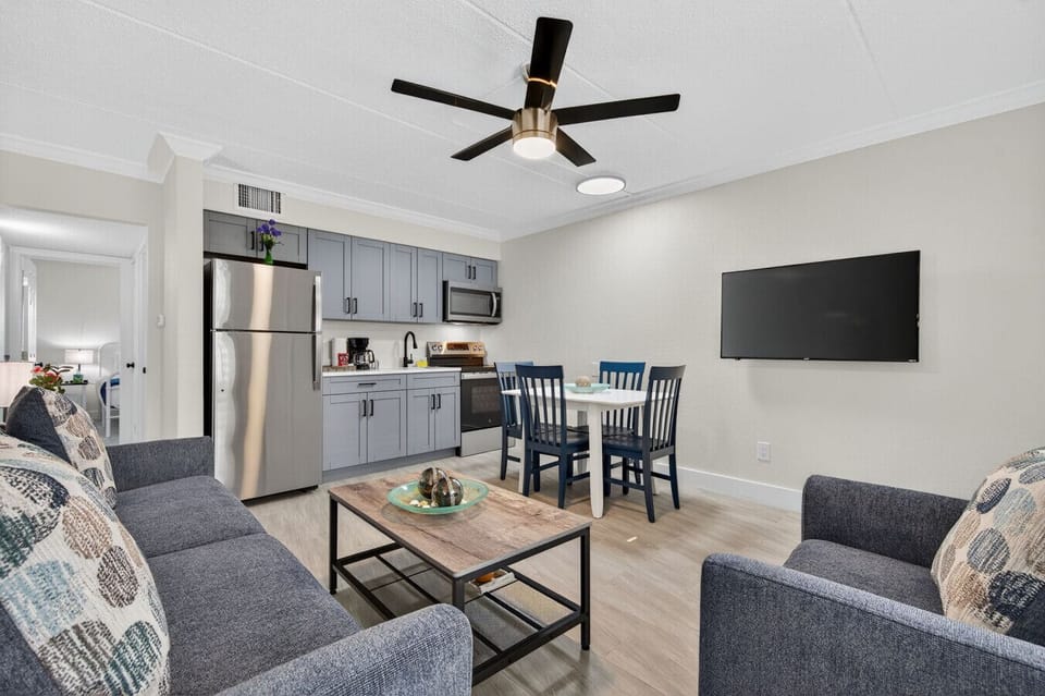 Bright open living space combining lounge, dining & kitchen areas for easy group gatherings.