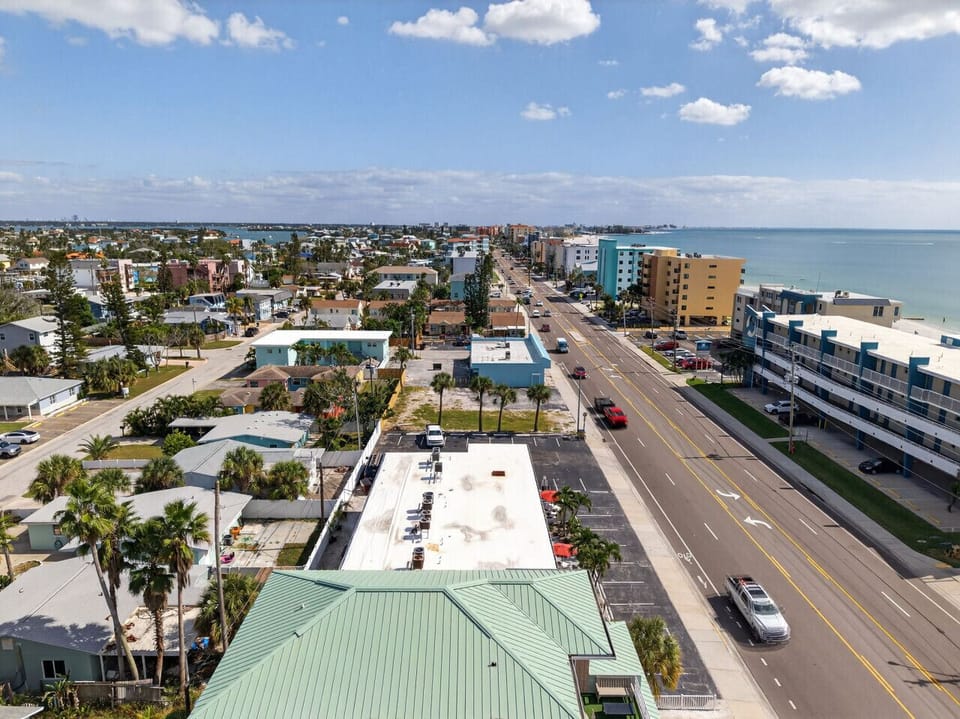 Elevated perspective highlighting nearby streets, buildings, and the laid-back coastal setting.