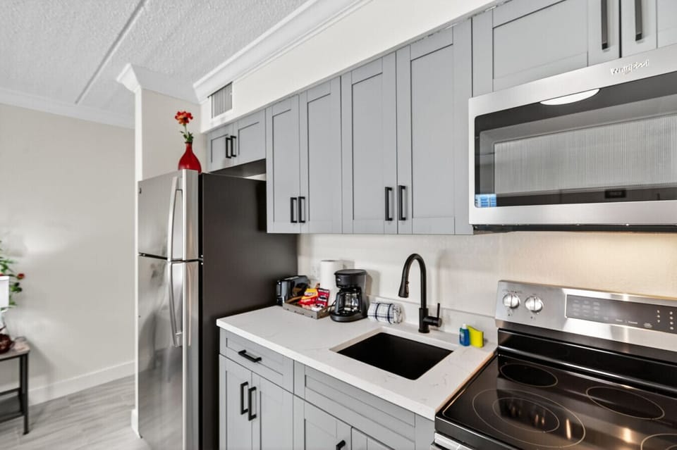 Sleek kitchen details w/ ample counter space and modern appliances for stress-free cooking.