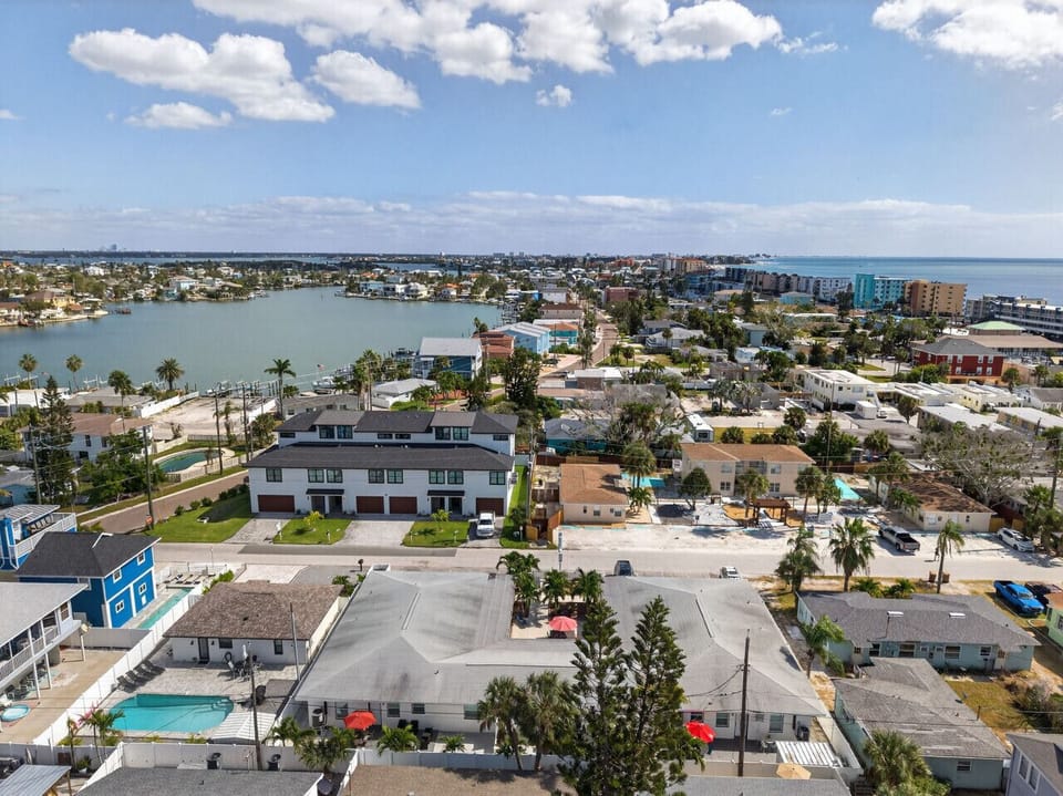 Expansive aerial scene blending rooftops, canals, & open water