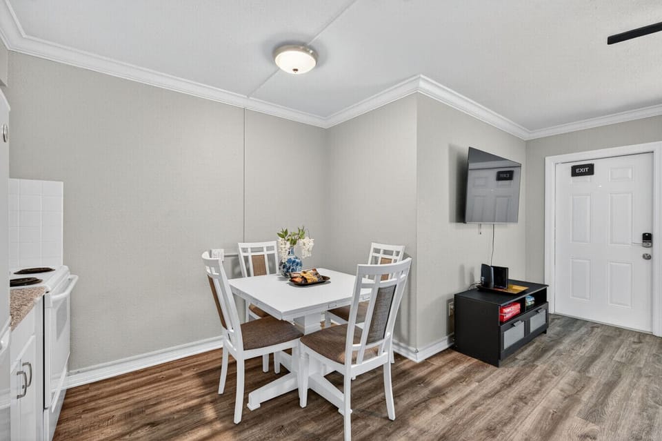 Cozy dining nook set for easy meals, w/ simple decor & plenty of natural light.