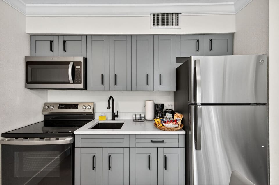 Sleek kitchen w/ stainless appliances, clean lines & everything set up for easy cooking.