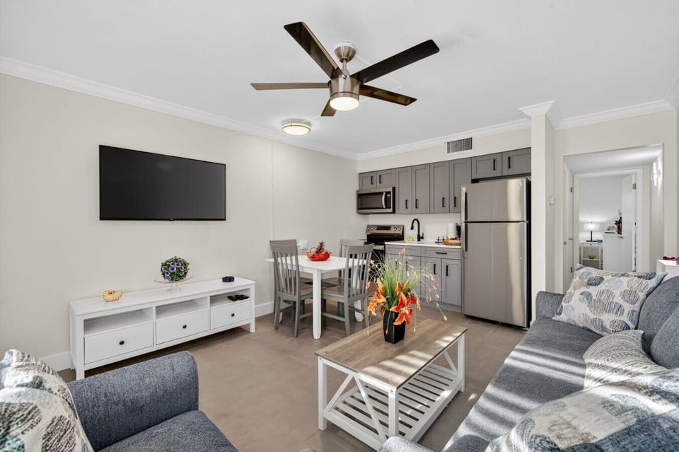 Modern living space w/ TV, dining table & kitchen nearby for effortless everyday living.