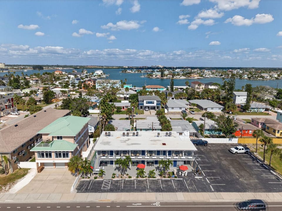 Wide aerial perspective showcasing the neighborhood layout & nearby waterways.
