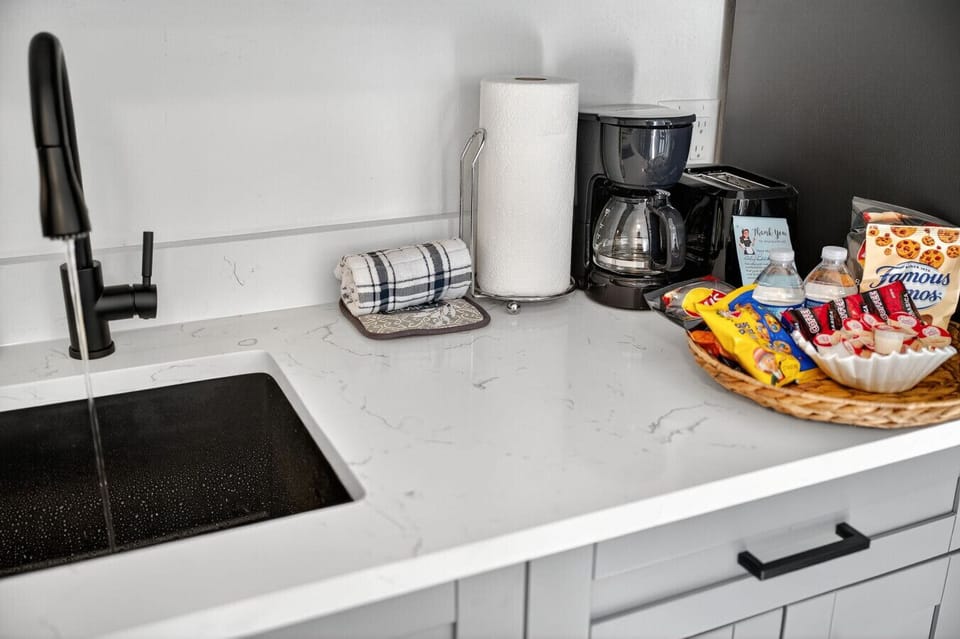 Functional kitchen counter w/ coffee maker, prep space & thoughtful touches for your stay.