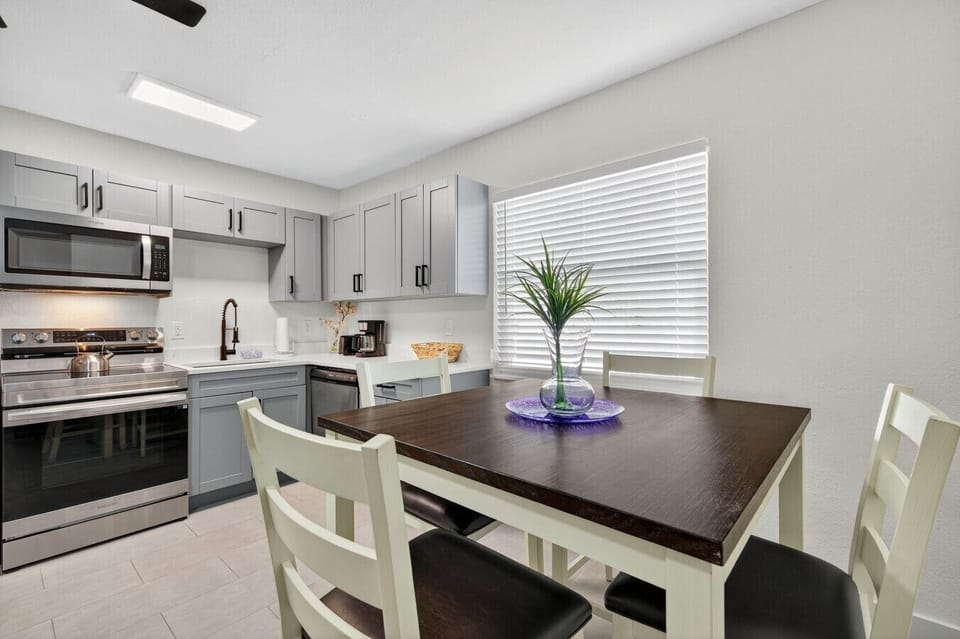 Dining table set beside the kitchen, perfect for shared meals & conversation.