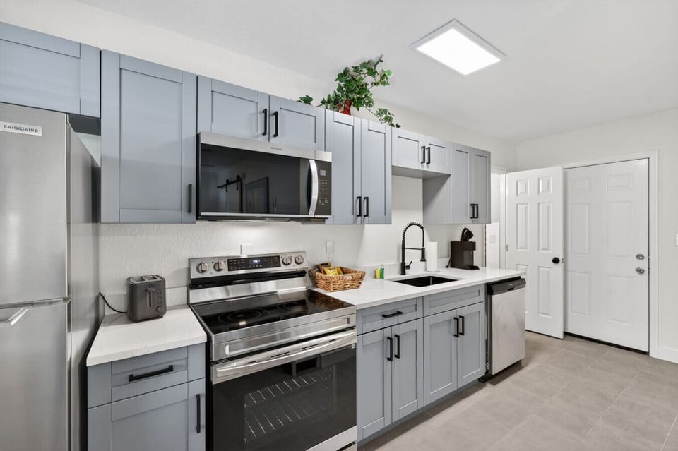 Sleek modern kitchen w/ clean lines & plenty of counter space to prep meals with ease