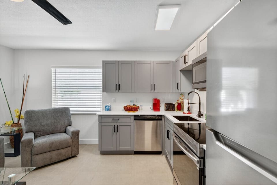 Sleek kitchen design w/ stainless appliances, ample counter space, and modern cabinetry.