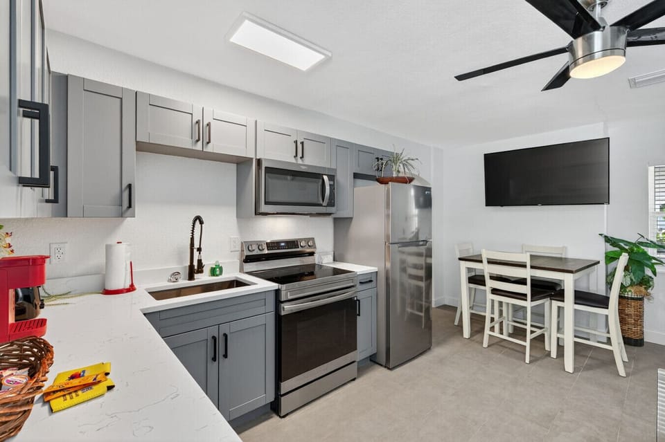 Bright kitchen w/ stainless appliances, clean lines, and a cozy dining nook.