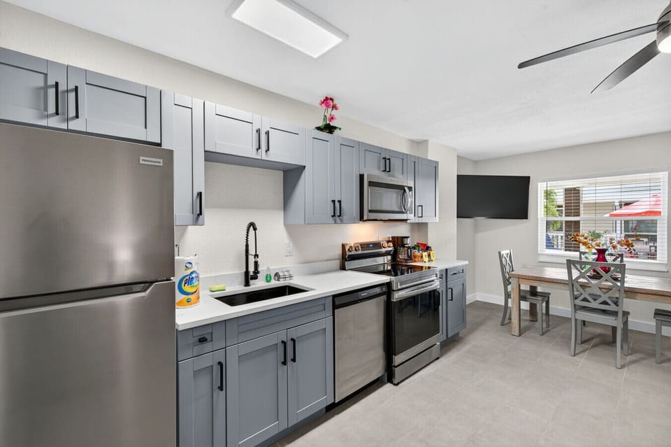 Open kitchen layout w/ stainless steel appliances & room to prep and gather.
