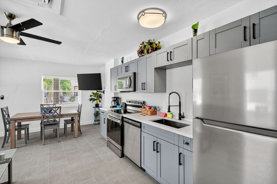 Modern kitchen w/ stainless steel appliances, generous counter space, & a clean, airy feel.