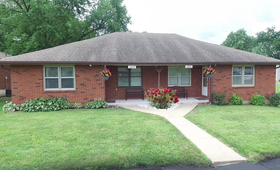 Charming brick home with spacious front yard and porch