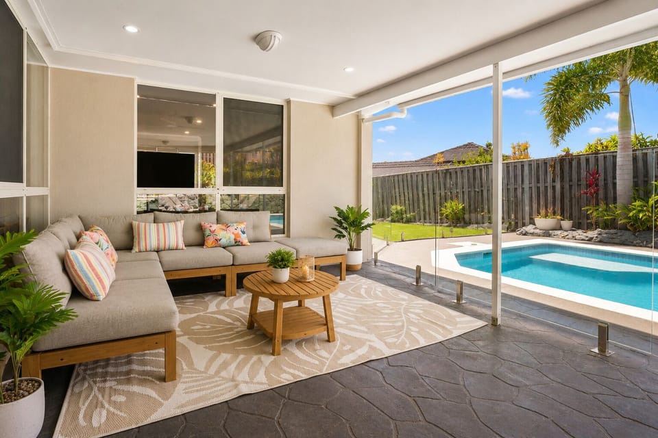 Covered patio with cozy seating and views of the pool.
