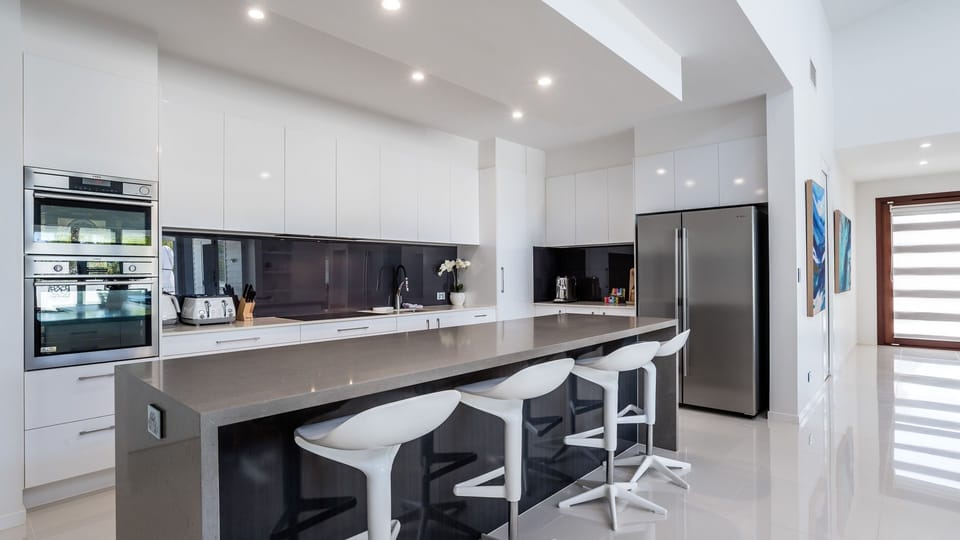 Sleek kitchen with breakfast bar and modern appliances.