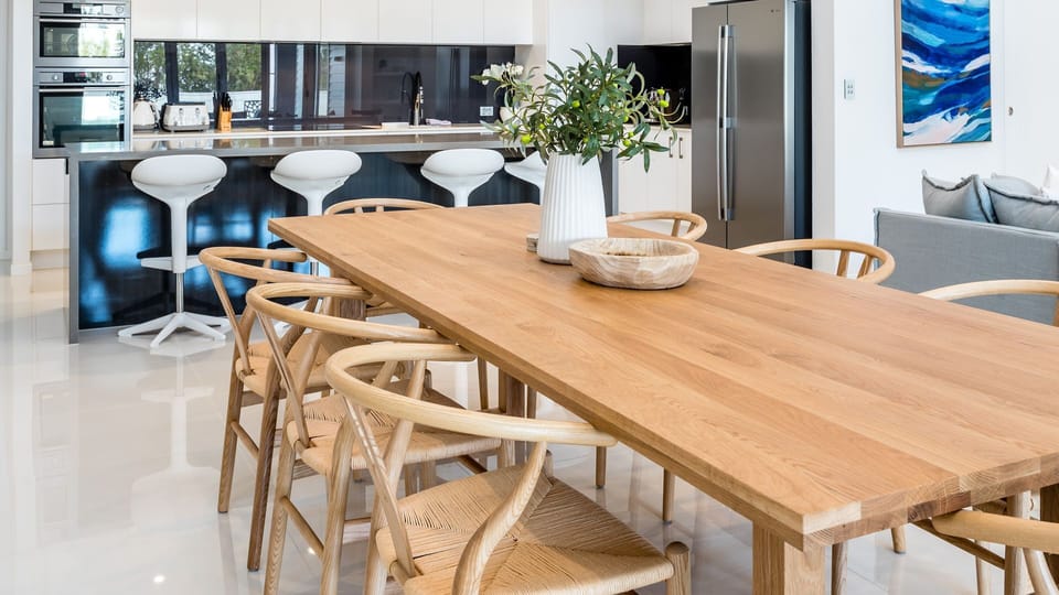 Family-sized dining table overlooking the kitchen area.