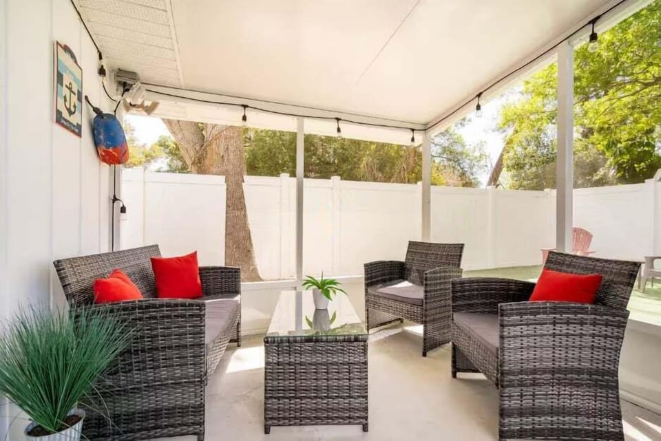 Screened-in porch with comfy outdoor furniture for a beautiful outdoor seating area!