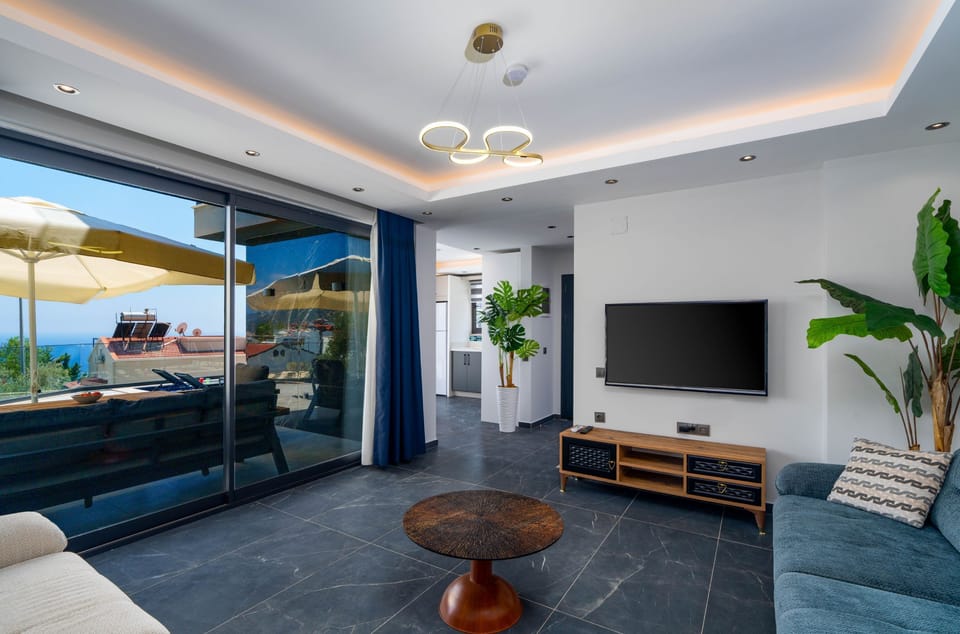 Spacious lounge with air con and patio doors to the terrace