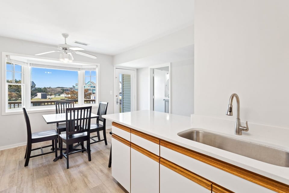Prepare fresh meals or quick snacks in the updated kitchen featuring modern appliances and stone countertops.