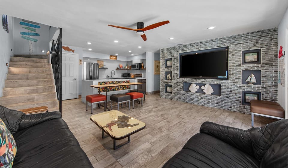 Sink into the sectional for movie night by the stone wall