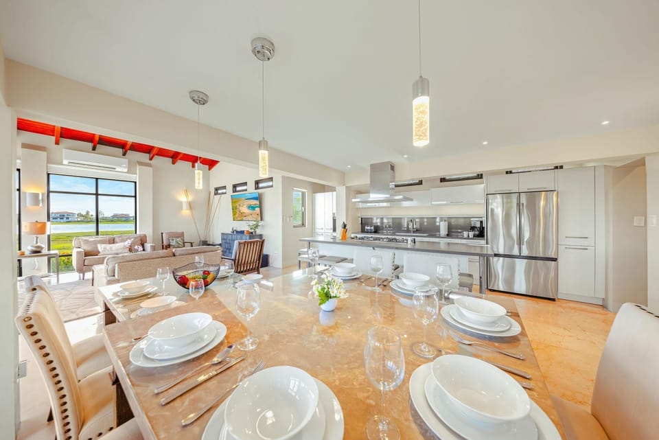 Bright, inviting, and effortlessly stylish. Our indoor dining area features seating for the whole family, elegant modern lighting, and a comfortable atmosphere for your favorite vacation meals.